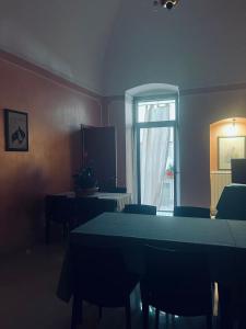 a dining room with a table and chairs and a window at B&B Rosy in Corato