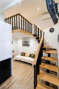 a bedroom with a bed in a room with stairs at Louis House in Rhodes Town