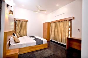 a bedroom with a bed and a window at MT'S Villas in Batheri +39 photos