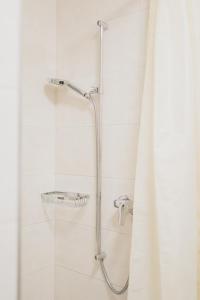 a shower with a shower curtain in a bathroom at La Caquerelle in Col des Rangiers +43 photos