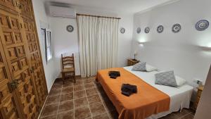 a bedroom with a bed with two towels on it at Villa Amistad in Orba