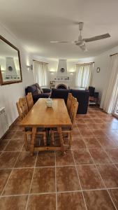 a living room with a wooden table and chairs at Villa Amistad in Orba