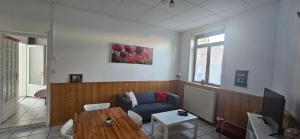a living room with a couch and a table at Les Gites D'Angres in Angres