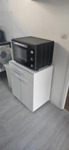 a tv sitting on top of a white table at Les Gites D'Angres in Angres +34 photos