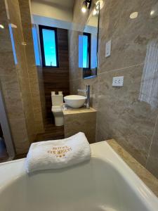 a bathroom with a white towel on a tub at Hotel San Miguel Cusco in Cusco