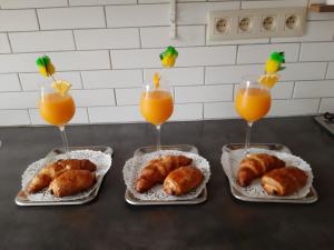 four plates of pastries and two glasses of orange juice at Zen Olive Guest Room in Antwerp
