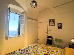 a bedroom with a bed and a window at Apartment Risorgimento Apartment by Interhome in Cipressa +17 photos