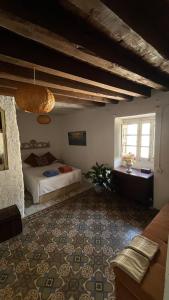 a bedroom with two beds and a couch in a room at DeMaJia. Casa entera: en Castillejo de Robledo in Castillejo de Robledo +41 photos