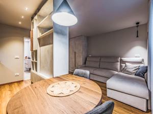 a living room with a table and a couch at Apartment La Spada by Interhome in Ossana