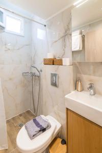 a bathroom with a sink and a toilet and a shower at Louis House in Rhodes Town +58 photos