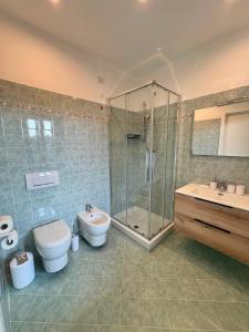a bathroom with a shower and a toilet and a sink at Villa Seli in Dogliani