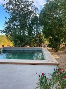 a pool of water with trees in the background at Dormir Ben Aise Hammam Massages in Maillezais