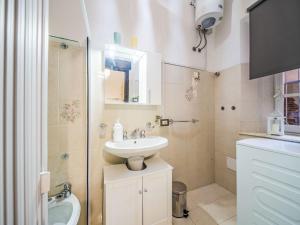 a small bathroom with a sink and a toilet at Apartment Nido nel centro by Interhome in Camaiore +14 photos