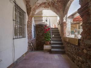 a brick hallway with stairs and a potted plant at Apartment Nido nel centro by Interhome in Camaiore