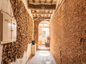 an alley in an old building with a brick wall at Apartment Nido nel centro by Interhome in Camaiore
