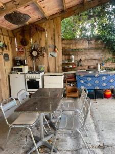 a kitchen with a table and chairs and a stove at Dormir Ben Aise Hammam Massages in Maillezais