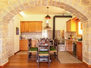 an archway in a kitchen with a table and chairs at Villa S'Olioni by Interhome in Loceri