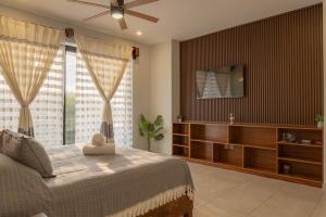 a bedroom with a bed and a large window at EOS Suites in Santa Cruz Huatulco