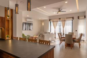 a kitchen and living room with a table and a couch at EOS Suites in Santa Cruz Huatulco +33 photos