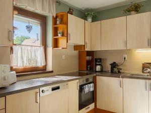 a kitchen with white cabinets and a window at Apartment Times by Interhome in Badacsonytördemic