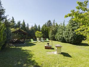 a yard with a group of chairs and a gazebo at Apartment Times by Interhome in Badacsonytördemic