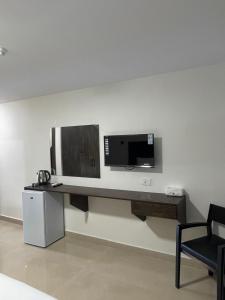 a television on a wall in a room at Zaina Plaza Hotel in Amman