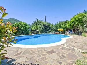 a swimming pool with blue water in a yard at Holiday Home Luce by Interhome in Dicomano +16 photos