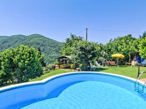 a swimming pool with a view of the mountains at Holiday Home Luce by Interhome in Dicomano
