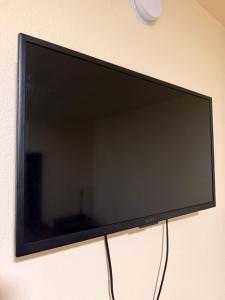 a flat screen tv hanging on a wall at Golden Knight Motel in Gresham