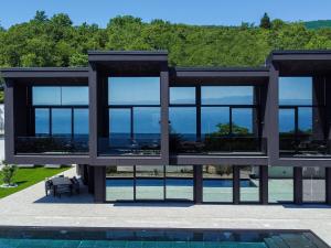 a house with a view of a swimming pool at Villa Black Imperium by Interhome in Mošćenička Draga
