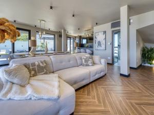 a living room with a white couch and a dining room at Villa Black Imperium by Interhome in Mošćenička Draga +61 photos