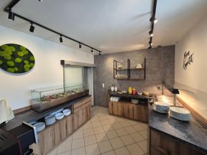 a restaurant kitchen with a counter with food at Appartementhaus Zraunig in Flattach +28 photos