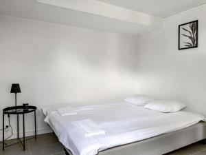 a white bed with white sheets and pillows at Apartment Odal by Interhome in Halmstad