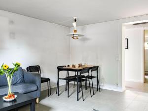 a living room with a table and a blue couch at Apartment Odal by Interhome in Halmstad