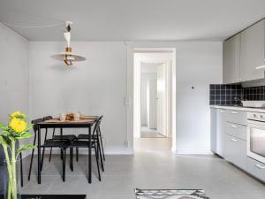 a kitchen with a table and chairs in a room at Apartment Odal by Interhome in Halmstad +14 photos