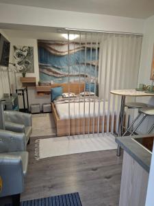 a bedroom with a bed and a table in a room at Frix Balaton in Balatonalmádi