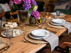 a wooden table with plates and flowers on it at Chalet Ivica by Interhome in Sveti Rok