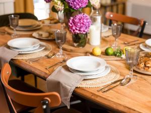 a wooden table with plates and dishes on it at Chalet Ivica by Interhome in Sveti Rok