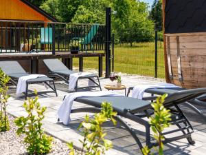 a group of chairs sitting on a patio with a playground at Chalet Ivica by Interhome in Sveti Rok +34 photos