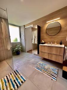 a bathroom with a sink and a mirror at Suite Hortensia in Breuil-Barret