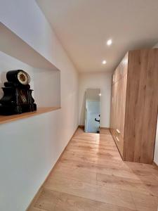 a hallway with white walls and wooden cabinets at Suite Hortensia in Breuil-Barret