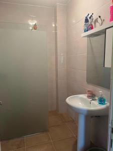 a bathroom with a white sink and a shower at Aparts 3 F3 BEJAIA VACANCE in Bejaïa +5 photos