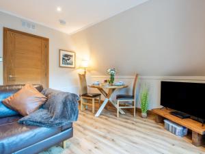 a living room with a couch and a table at Chalet Glengarry Combi by Interhome in Spean Bridge +44 photos