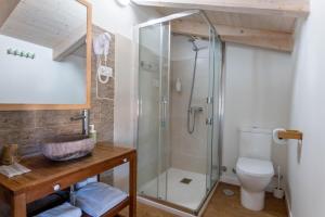 a bathroom with a glass shower and a toilet at La Casita de Melón in Suances +69 photos