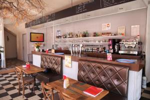 a restaurant with two tables and a bar at hôtel du centre in Saint-Benoît-du-Sault