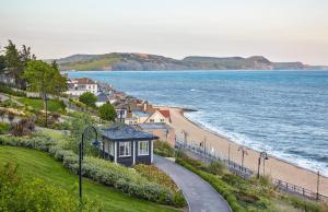a view of a beach with houses and the ocean at 1 Bed in Stoke Abbott oc-50885 in Stoke Abbott