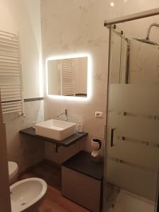 a bathroom with a sink and a toilet and a mirror at B&B Residenza Gigina in Sezze +12 photos