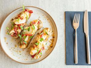 a plate of food on a table with a fork at Novotel Lisboa in Lisbon