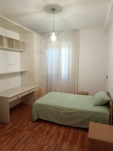 a bedroom with a bed and a desk and a desk at B&B Residenza Gigina in Sezze