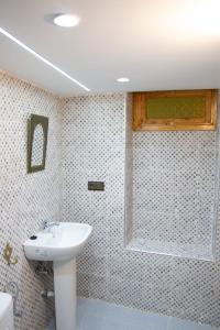 a bathroom with a sink and a shower at FATI GUEST HOUSe in Chefchaouen